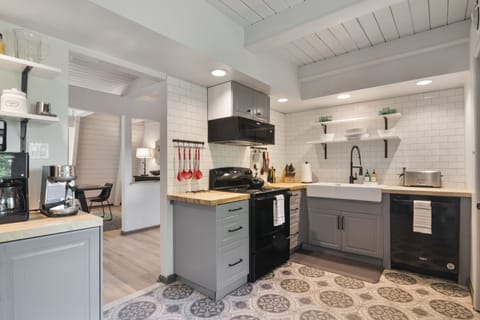 Functional fully stocked kitchen with all the dishes and appliances you need.