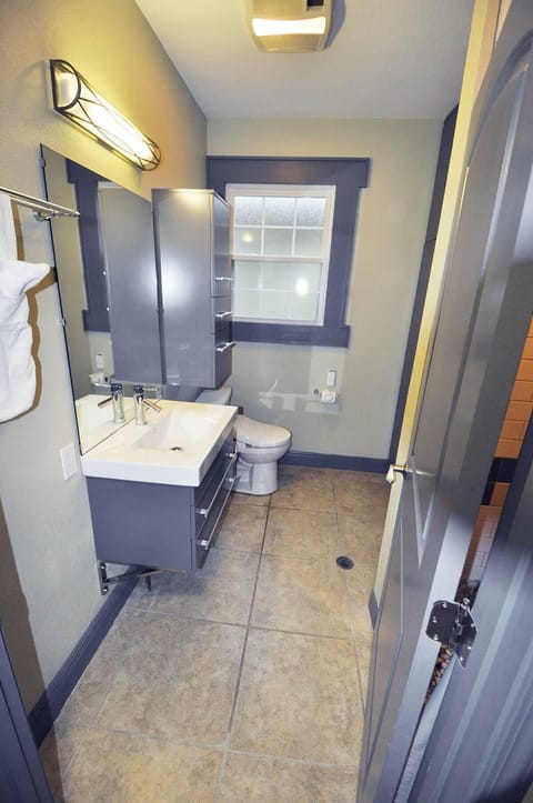 Bathroom has storage closets and built-in dresser.