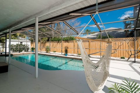 Relax in the patio area with the cool pool and hammock chair in Bradenton, FL