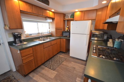 Full kitchen - Cookware, Coffee maker, Microwave, Refrigerator, Slow cooker, Toaster, Toaster oven, Utensils, Stove top gas, Pantry items, Dining table.