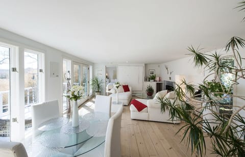View of living room. Windows offer panoramic view of gardens and creek.