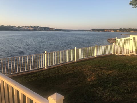Fenced in grassy area off of patio