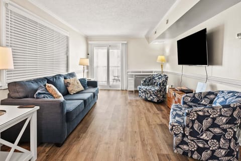 Living area with blue sectional seating at Summer Place C3, a 2-bedroom Cherry Grove condo rental
