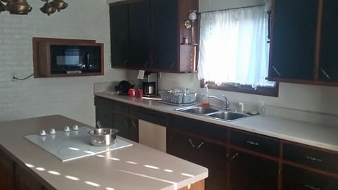 Another angle of the kitchen showing the dishwasher and deep sink.