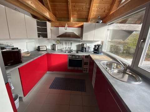 Cabinetry, Countertop, Kitchen, Automotive Design, Interior Design, Floor, Flooring, Kitchen Appliance, Major Appliance, Kitchen Stove