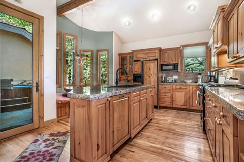 A separate patio hosts the private hot tub, perfect after a day on the mountain.