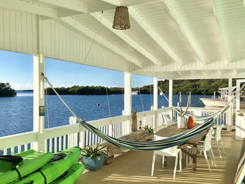 Spacious ocean front balcony with 2 hammocks, dinning table for 10 and seating.