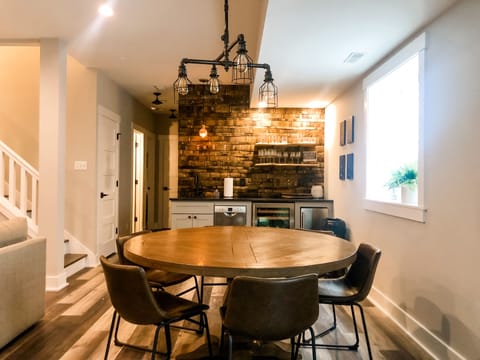 Lower level entertainment area includes game table and custom wet bar