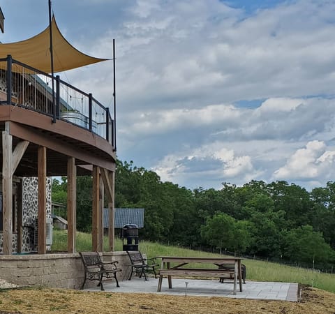 Lower patio area is shared a shared space. Includes benches, table & fire pit.