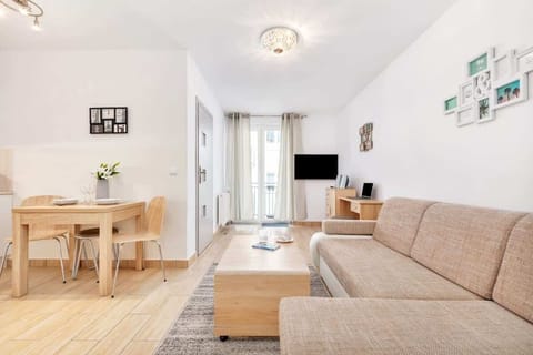 The elegant living room featuring a comfortable beige sofa perfect for relaxation.