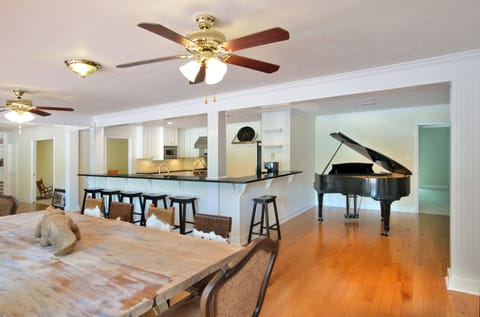 Baby grand piano off the kitchen and dining. 