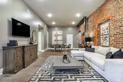 Open-concept living and dining area with ample seating for you and your guests. Relax on the large sectional after a fun-filled day in NOLA! Enjoy a Samsung Smart 4K TV for streaming and DIRECTV Entertainment. Dining table seats six.