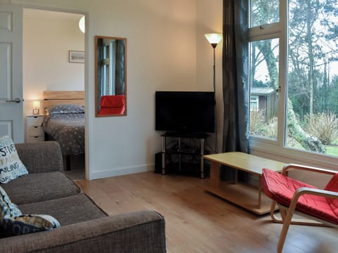 Comfortable living area and adjacent bedroom | Chalet 4 - Mount Hawke Holiday Bungalows, Mount Hawke, near Redruth