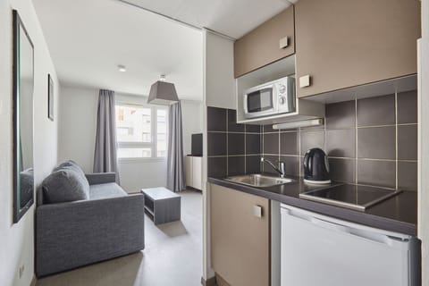 Compact kitchenette with modern appliances combining style and practicality for easy in-room dining.