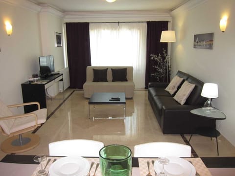 Livingroom with tv, heater, a/c, windows with electric blinds