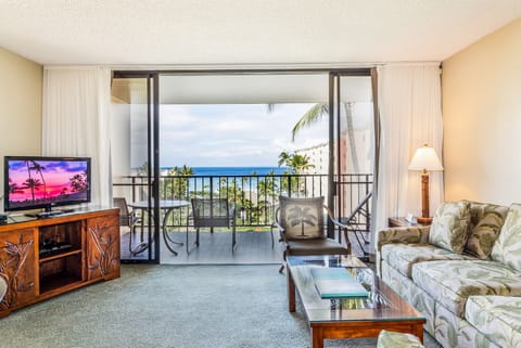 Step into your island retreat where tropical breezes and endless ocean views await. Your private balcony frames swaying palms and sparkling blue water—pure paradise at your fingertips.