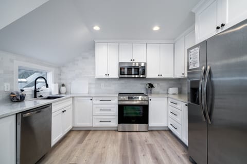 Custom cabinets, quartz counters and stainless steel appliances