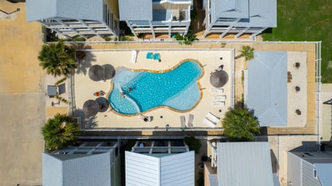 Pool Aerial — Bird's Eye Freeform Pool, Tiki Umbrellas, Swimmers & Surrounding Townhomes