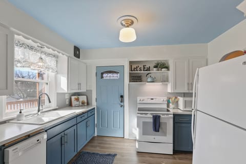 Kitchen with full size refrigerator and range.