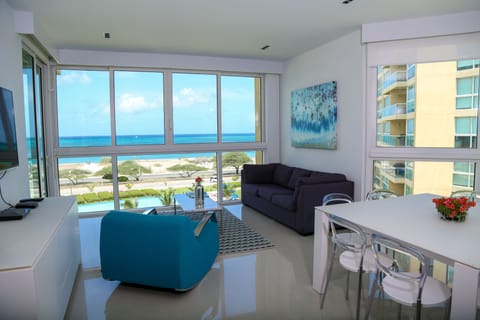 Soak in stunning ocean views from your bright, modern living space where coastal blues meet contemporary comfort, inviting you to unwind and savor every moment of your beachfront escape.