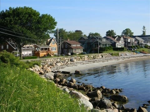 View of the cottage and the beach at high tide