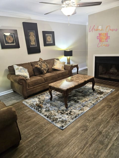 This elegant living room welcomes you with rich earth tones, a cozy fireplace, and tasteful decor.