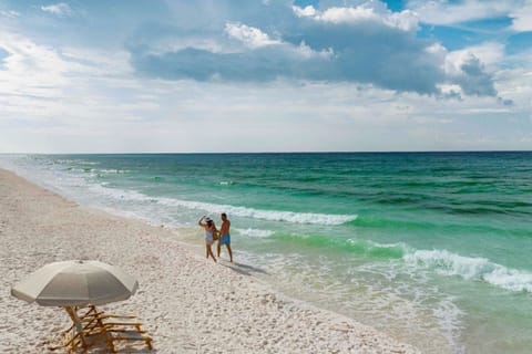 Indulge in the calm and solitude under a beach umbrella, with the soothing sounds of the sea.