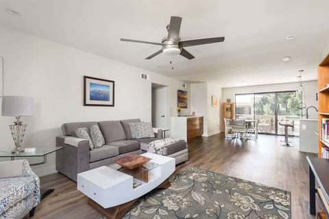 Modern open floor plan featuring a designer furnished living room with a flat-screen SMART TV overlooking the fully equipped kitchen.