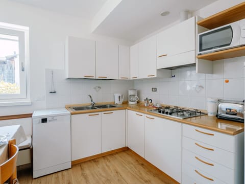 Cabinetry, Countertop, Sink, Tap, Kitchen Sink, Kitchen Stove, Wood, Kitchen Appliance, Building, Drawer