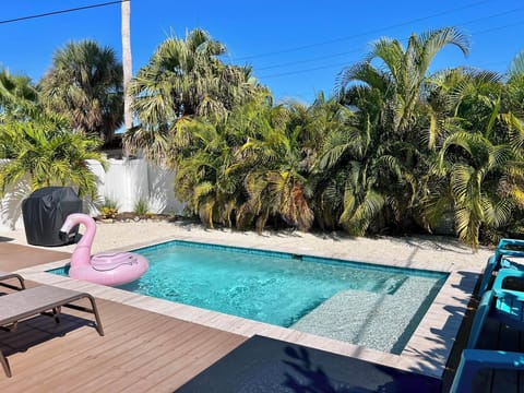 Pool area with tropical landscaping