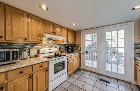 Kitchen, leading out to outdoor dining area with gas grill 