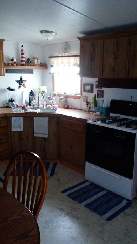 Double sink and full size gas stove/oven with full size refrigerator/freezer. 