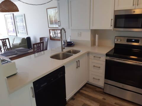 New kitchen with quartz counter tops and stainless steel appliances