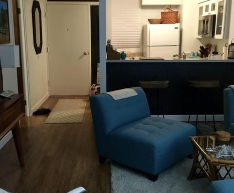 Looking from windows into condo
Two bar stools at counter