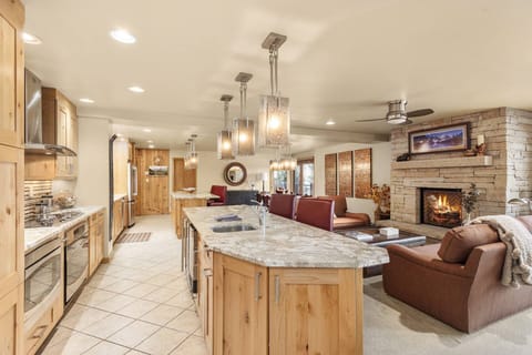The chef will love cooking and being able to enjoy the fire, view and company in this open-concept kitchen and living space.
