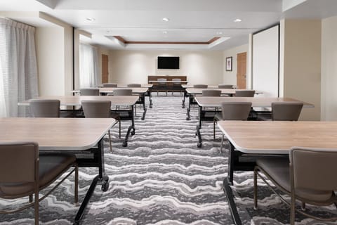Spacious meeting room with versatile seating and natural light.