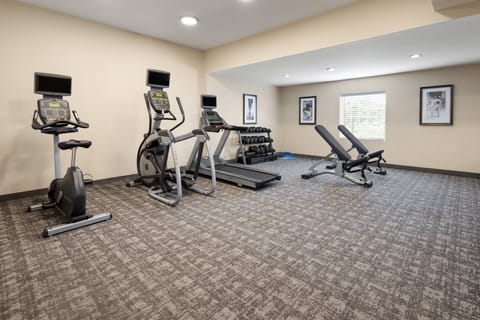 Modern fitness center featuring cardio machines and strength equipment.