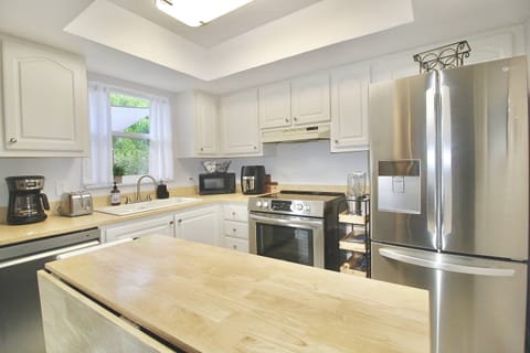 The well stocked kitchen boasts all brand new stainless steel appliances.