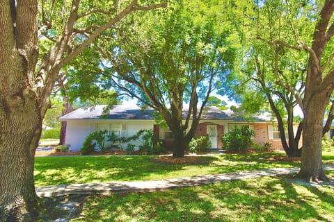 The Coastal Village Retreat sits on a corner lot surrounded by beautiful landscaping.