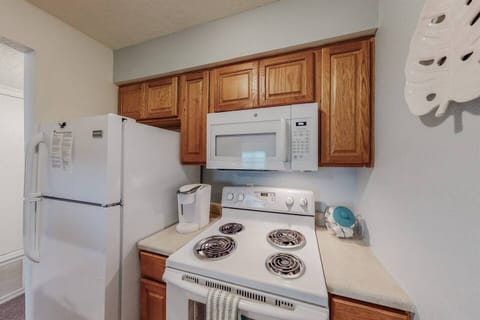 Kitchen includes electric stove, refrigerator, microwave, and dishwasher