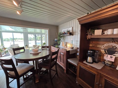 Another view of the kitchen area with adjacent sunroom