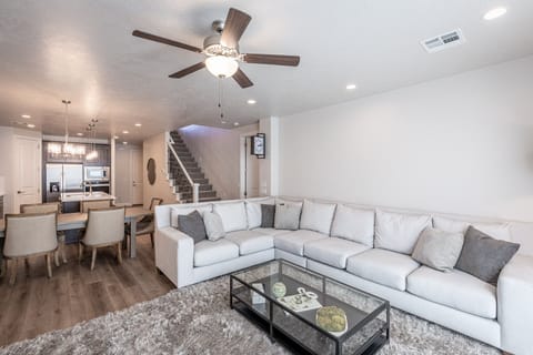 Family Room Sofa - The living room is designed as an open floor plan and is a great gathering place for meals, games, or watching TV during your stay.