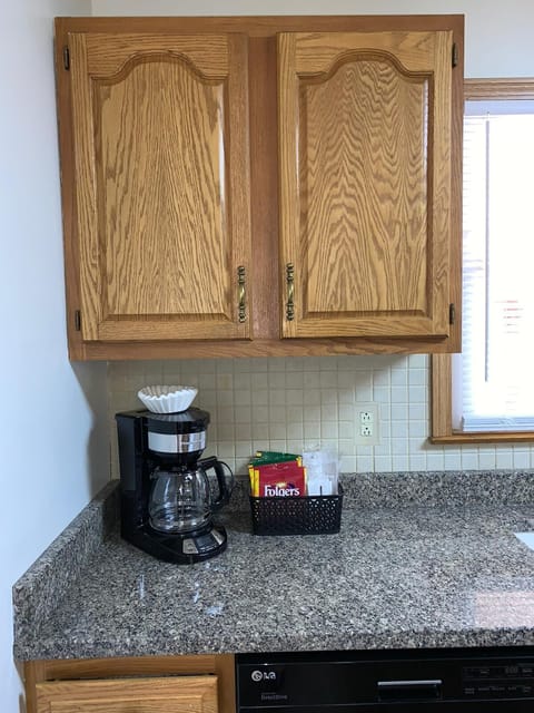 Coffee maker. Regular and decaf coffee are provided, sugar and creamer.