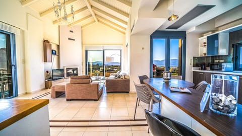 The modern living room with Smart TV, fireplace, stereo system and pool view!