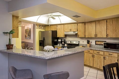 The kitchen boasts both a breakfast bar and a table. You choose.