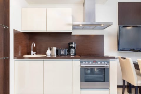 Kitchenette with oven and refrigerator.