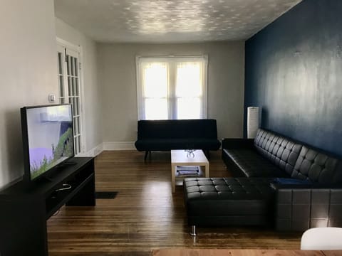 Large living room with dual futons for extra sleeping.