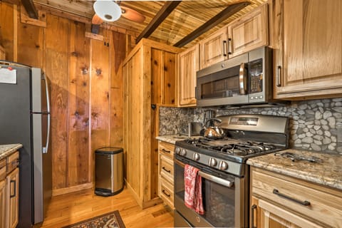 The efficient kitchen has a microwave and  gas range with grill.