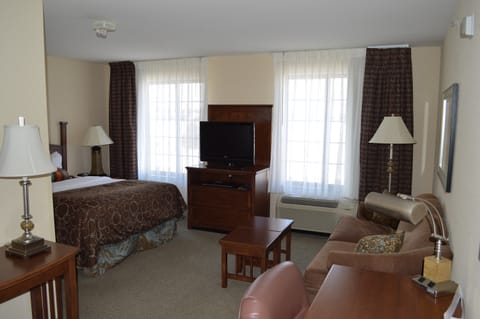 Spacious king studio suite with comfortable bed and living area.