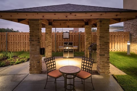 Grill up your favorite meals in this charming, sheltered outdoor space, perfect for evening gatherings.